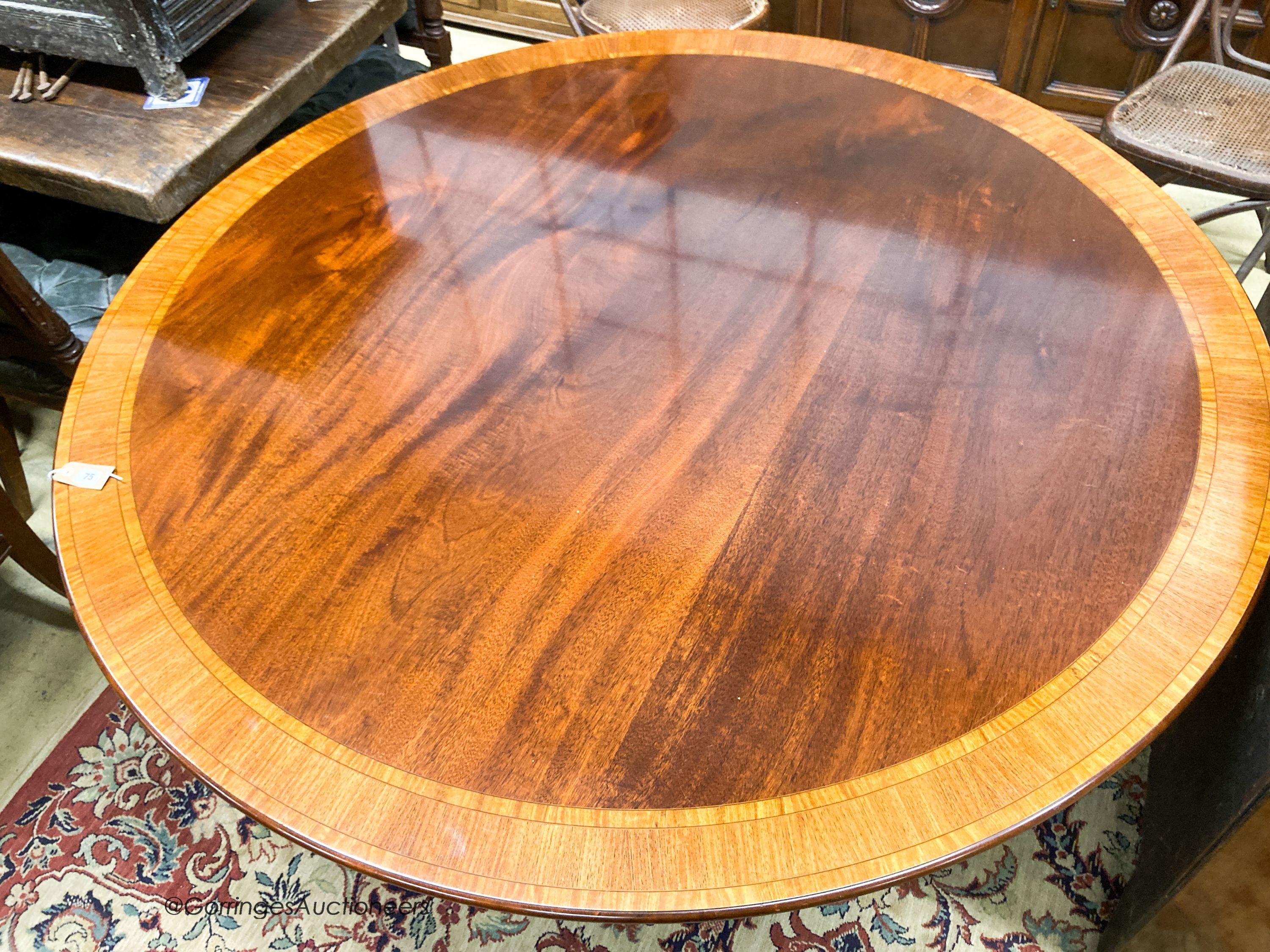 A William Tillman Georgian style mahogany and satinwood circular pedestal dining table